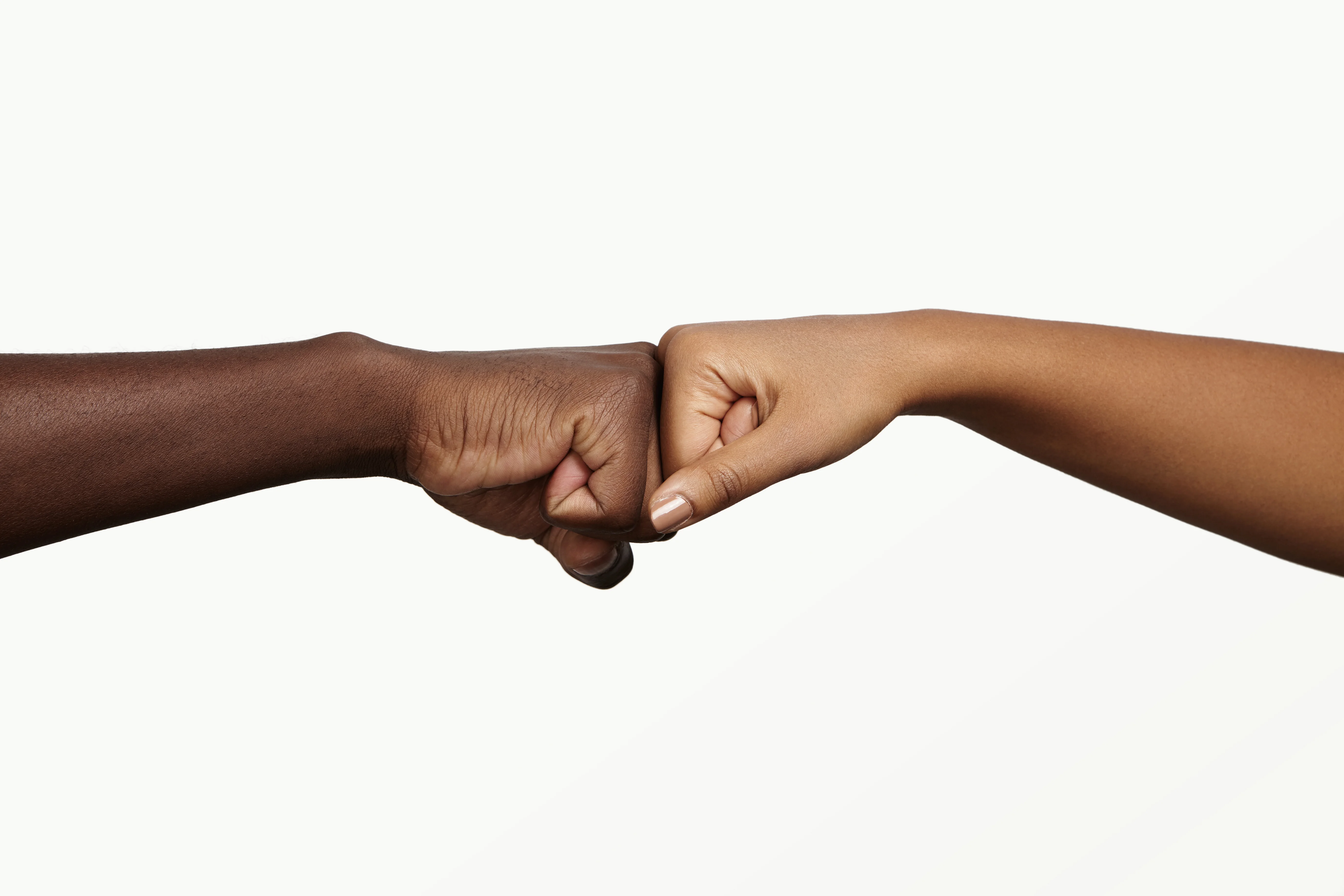 Fist bump between two hands symbolizing unity and friendship