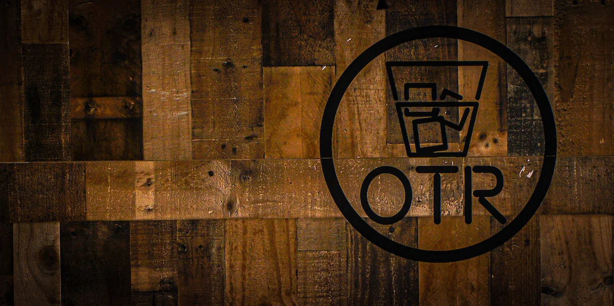 Stylish restaurant logo on rustic wooden wall