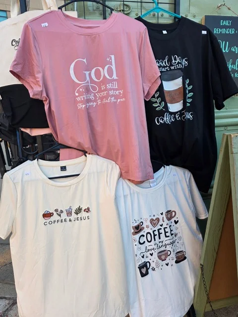 Colorful t-shirts with coffee and faith-themed designs