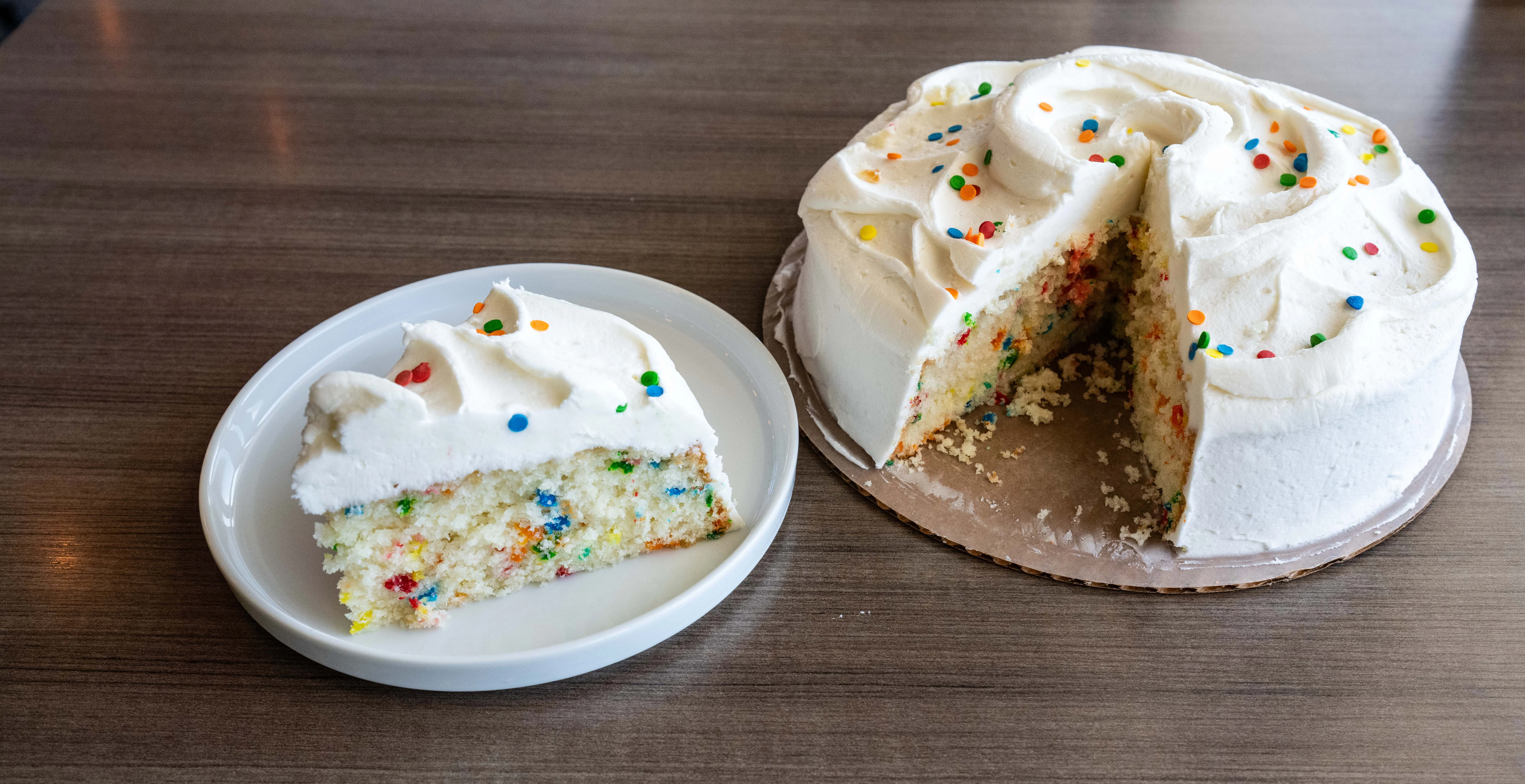 Red velvet cake with cream cheese frosting and decorative crumbs