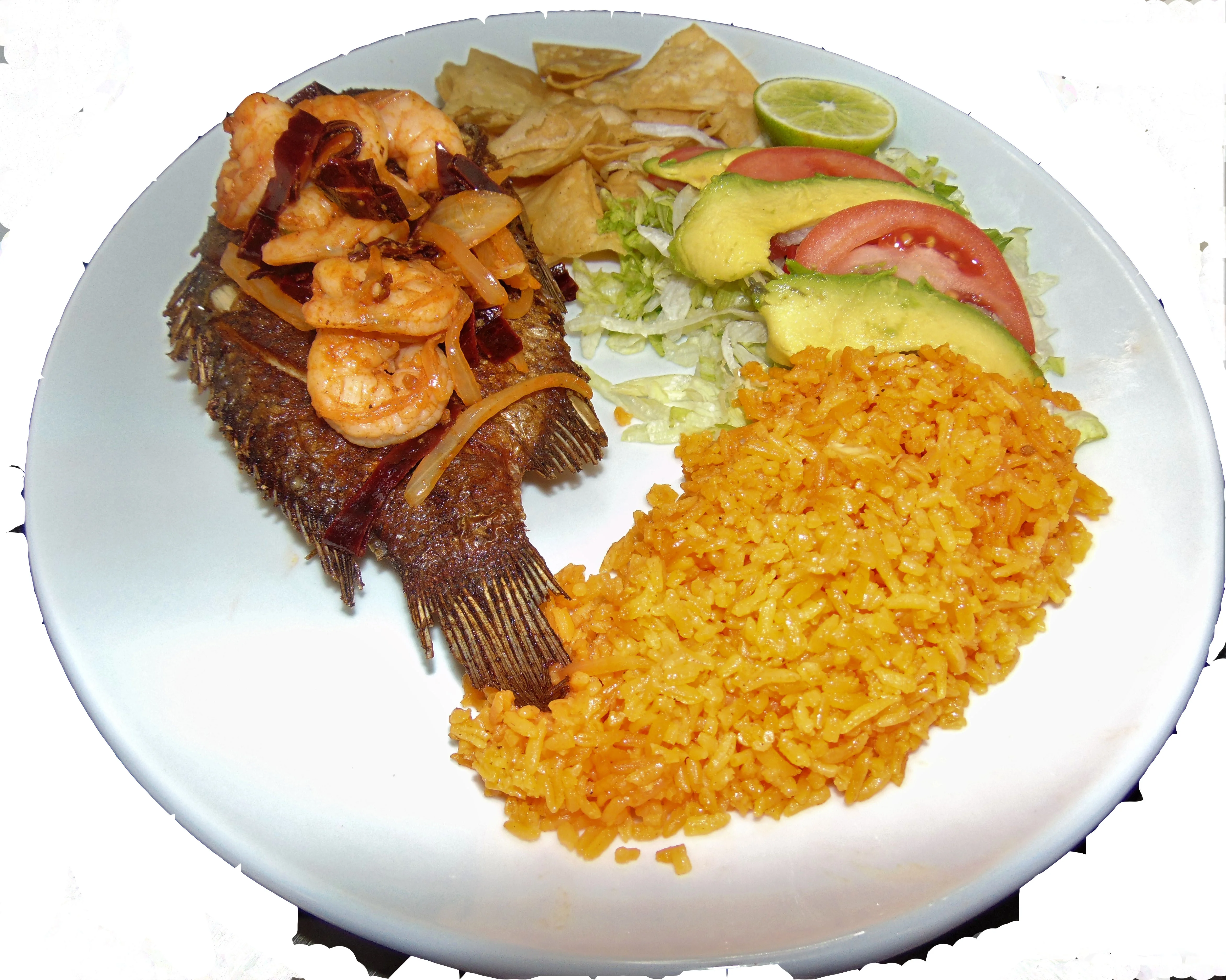 Fried whole fish with shrimp, rice, and salad, a classic Mexican dish