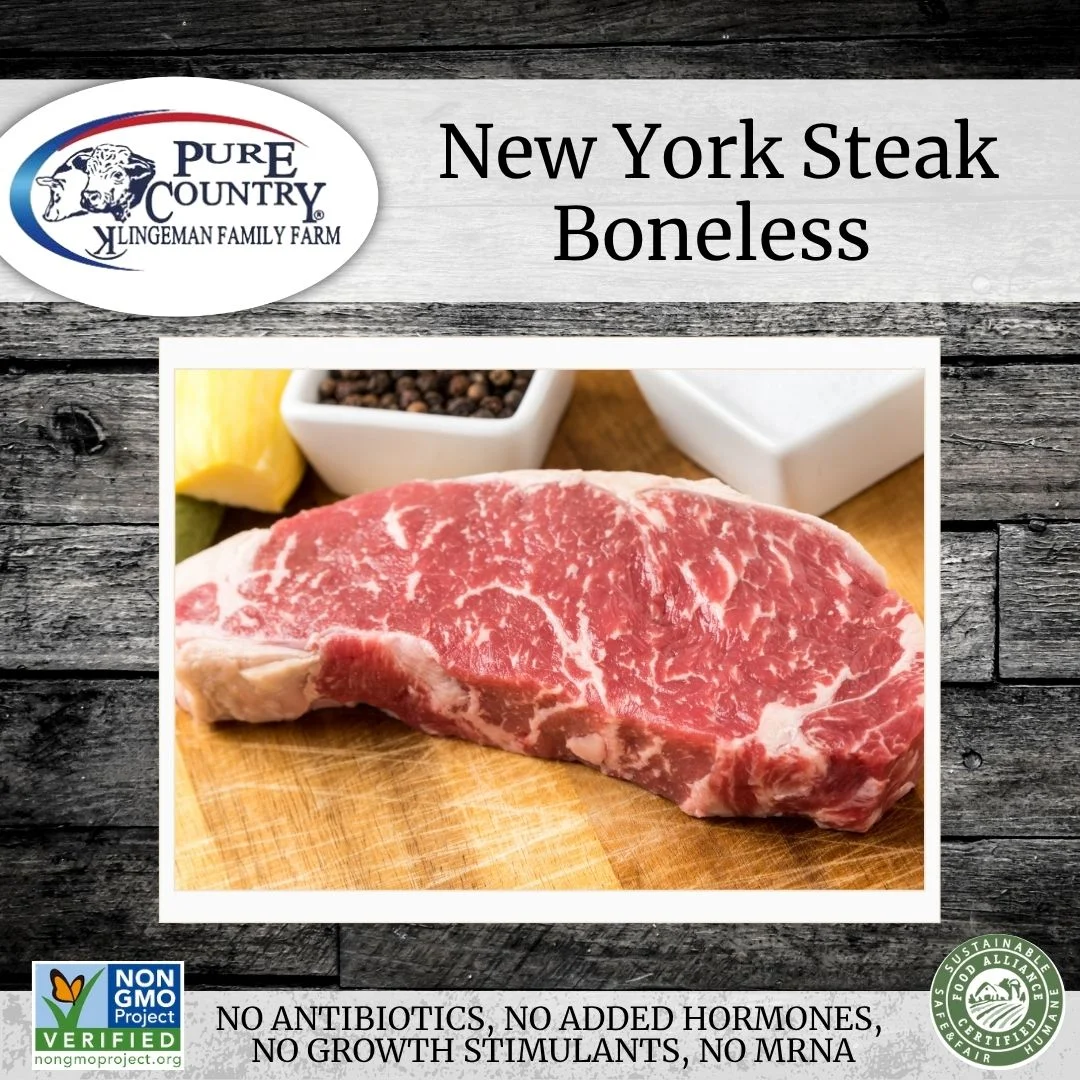 Boneless New York steak on a wooden board with spices