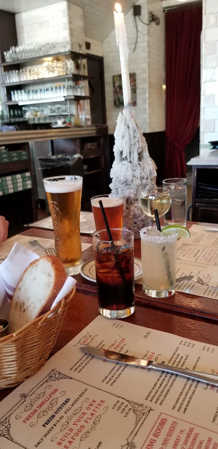 Cozy restaurant table with assorted drinks and fresh bread