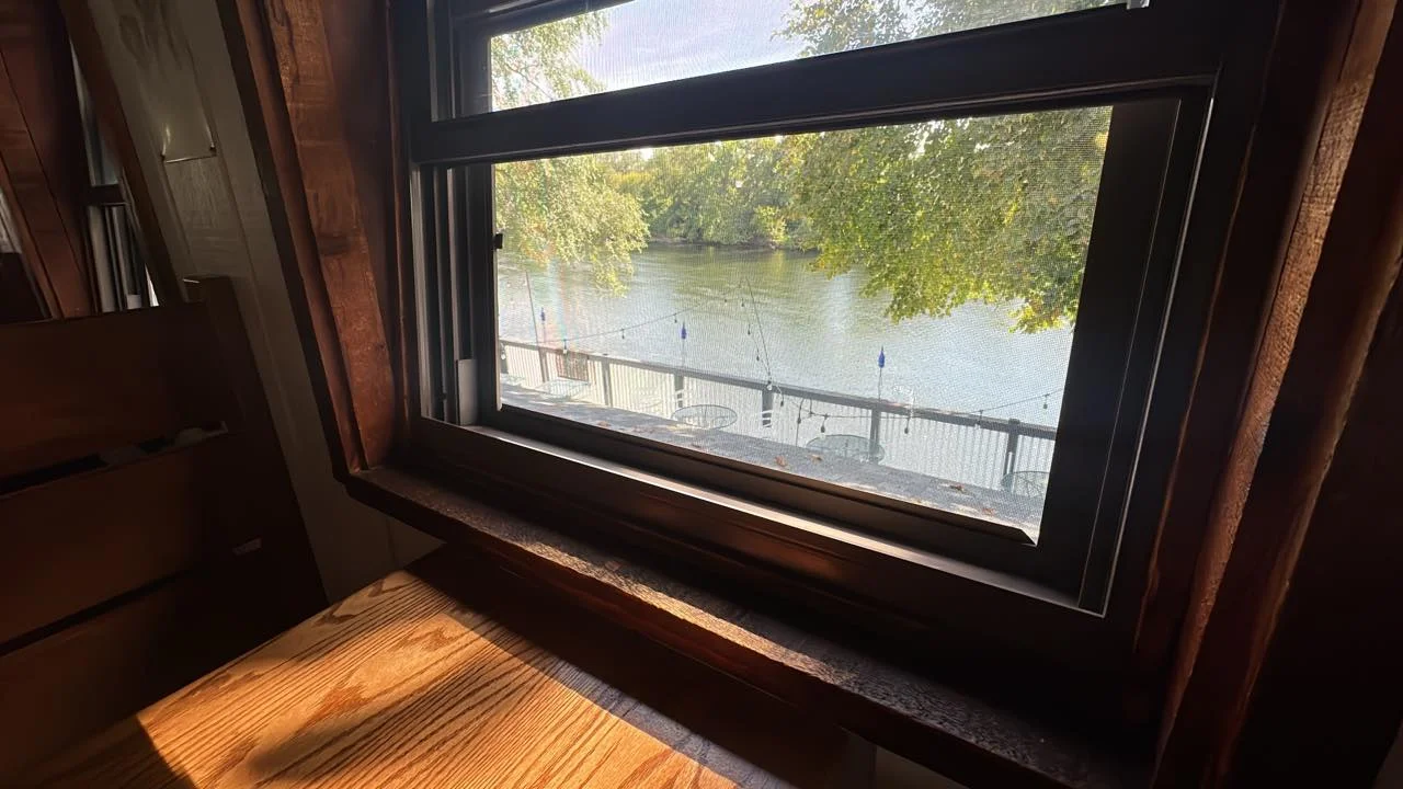 Scenic view of a river from a cozy restaurant window
