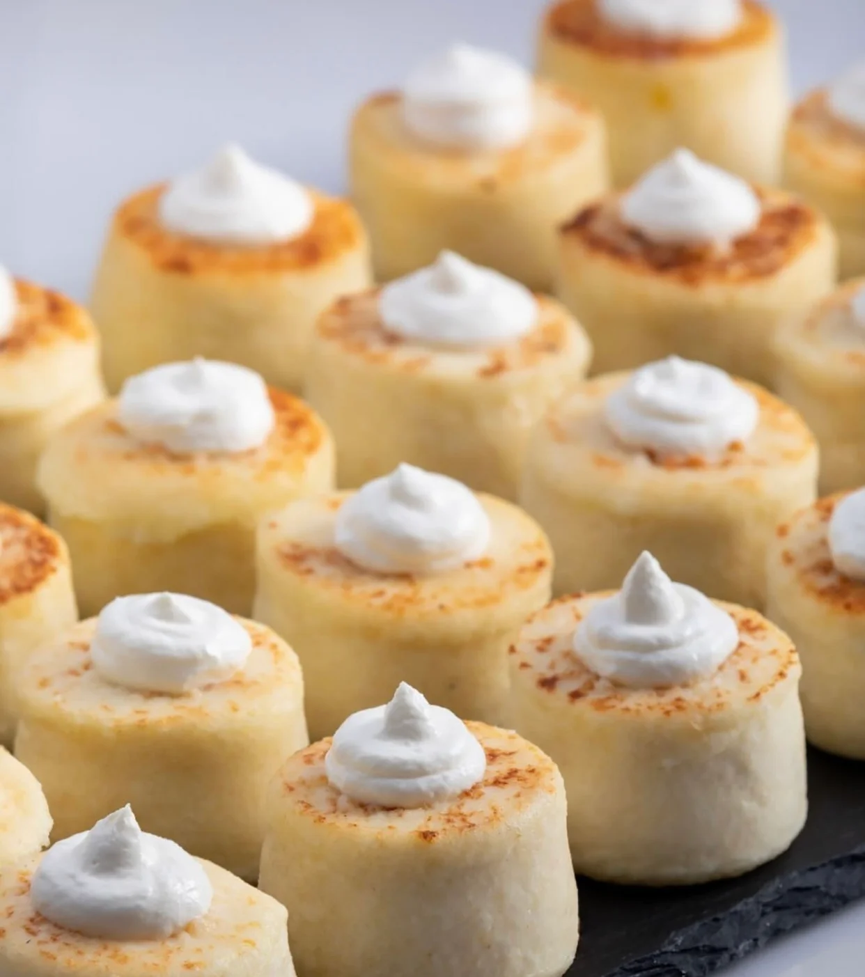 Delicious Brazilian beijinho sweets topped with coconut cream