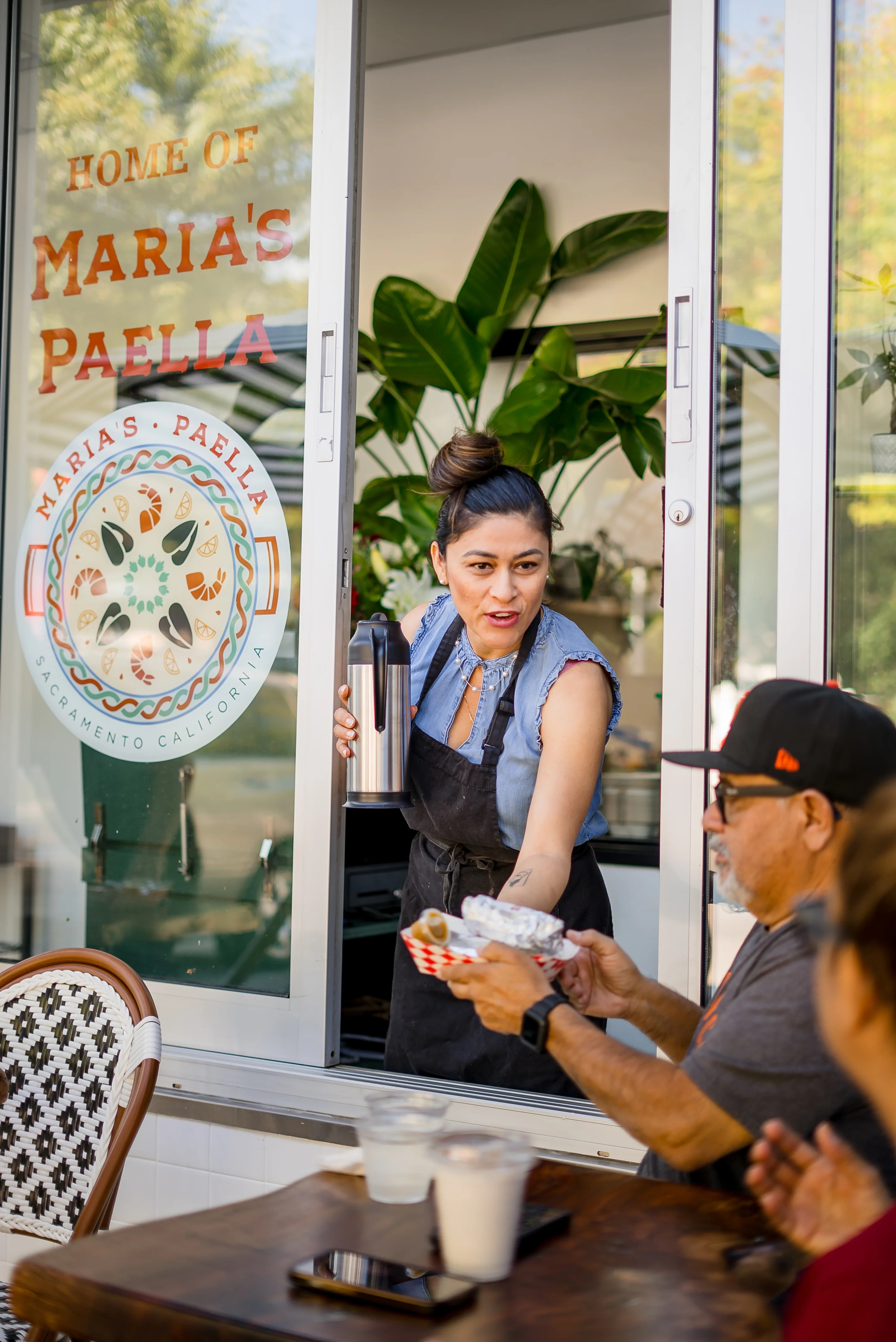 Serving paella at a vibrant restaurant window