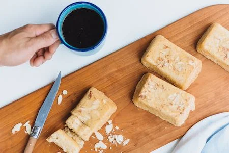 Freshly baked almond cake slices with coffee
