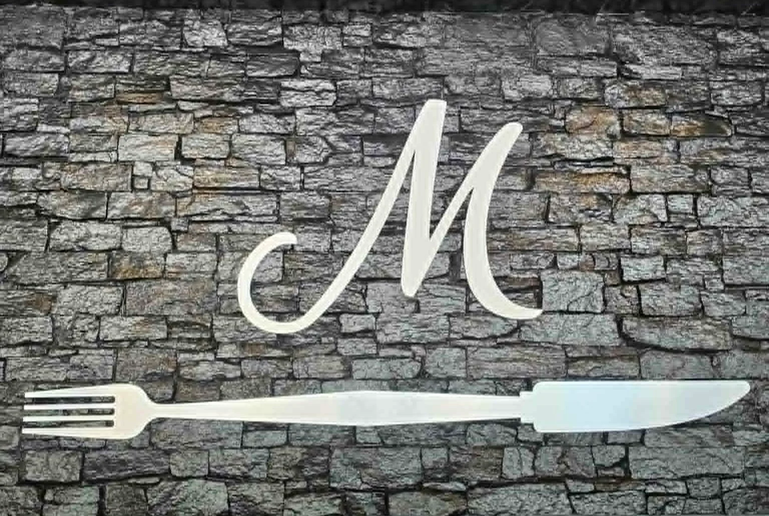 Stylish restaurant interior with stone wall and elegant logo