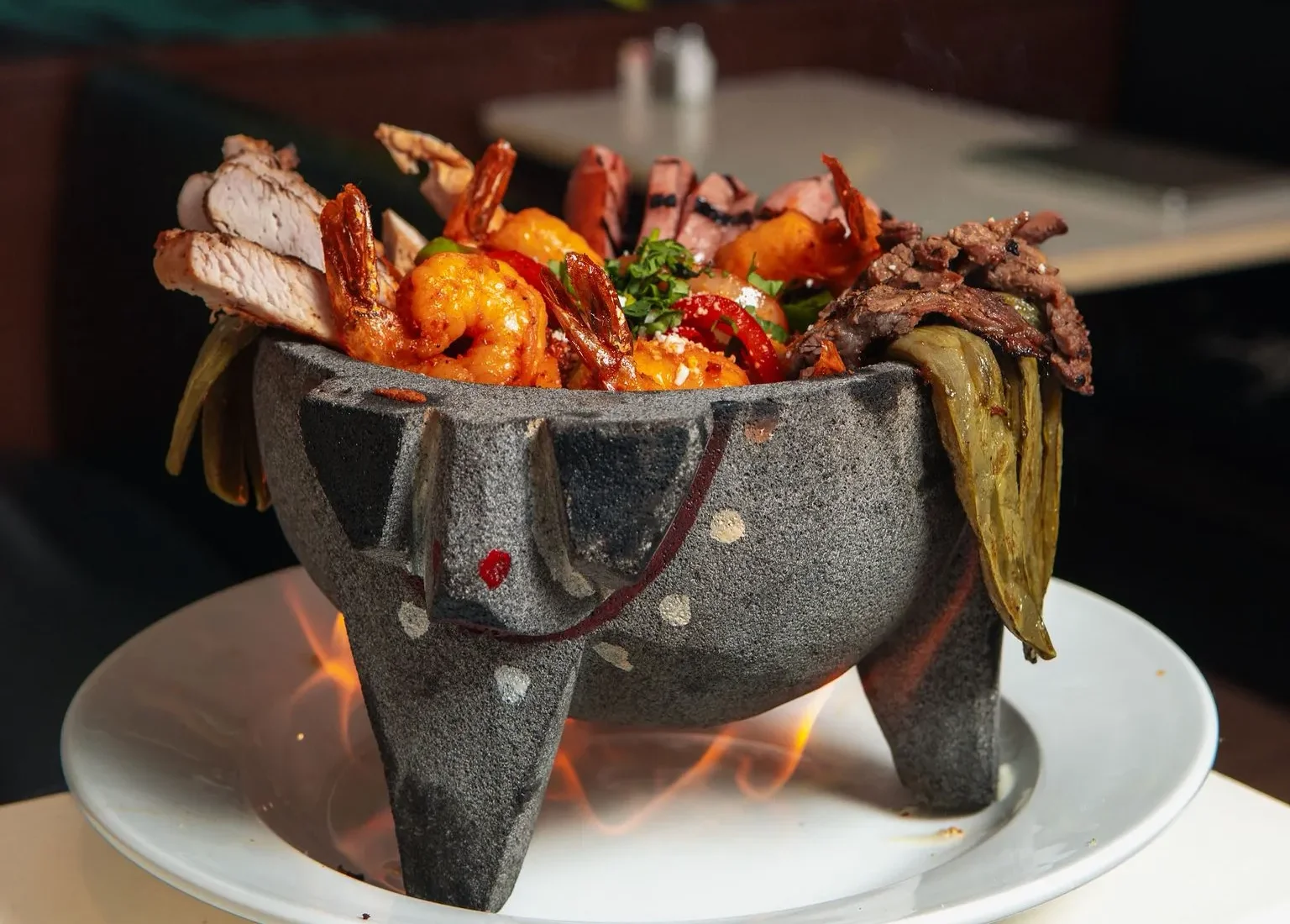 Sizzling Mexican fajitas served in a traditional stone bowl