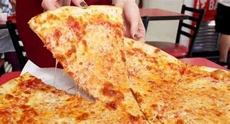 Cheesy New York-style pizza slice being served