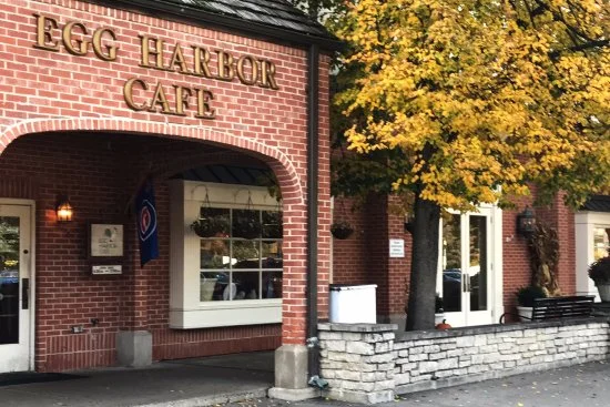 Charming restaurant exterior with brick facade and autumn foliage