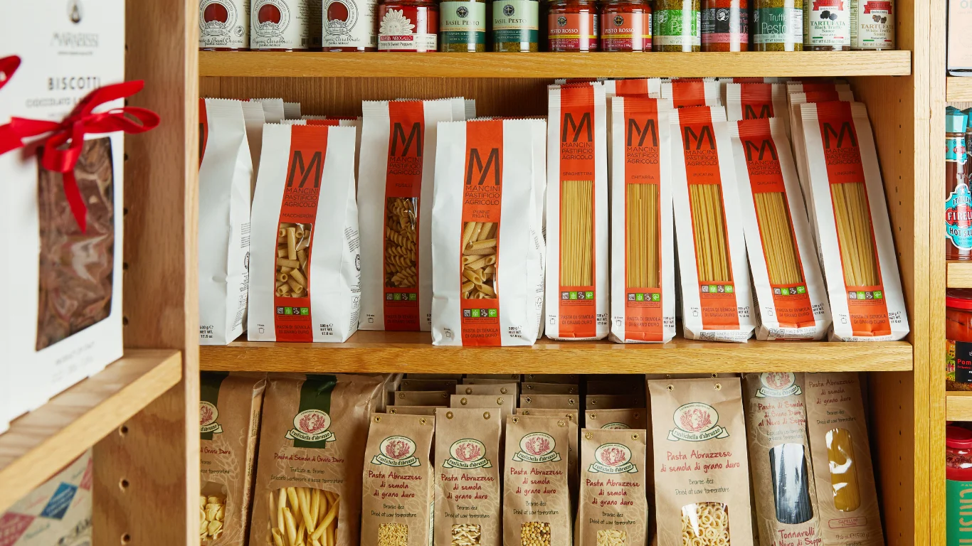 Italian pasta varieties on a wooden shelf