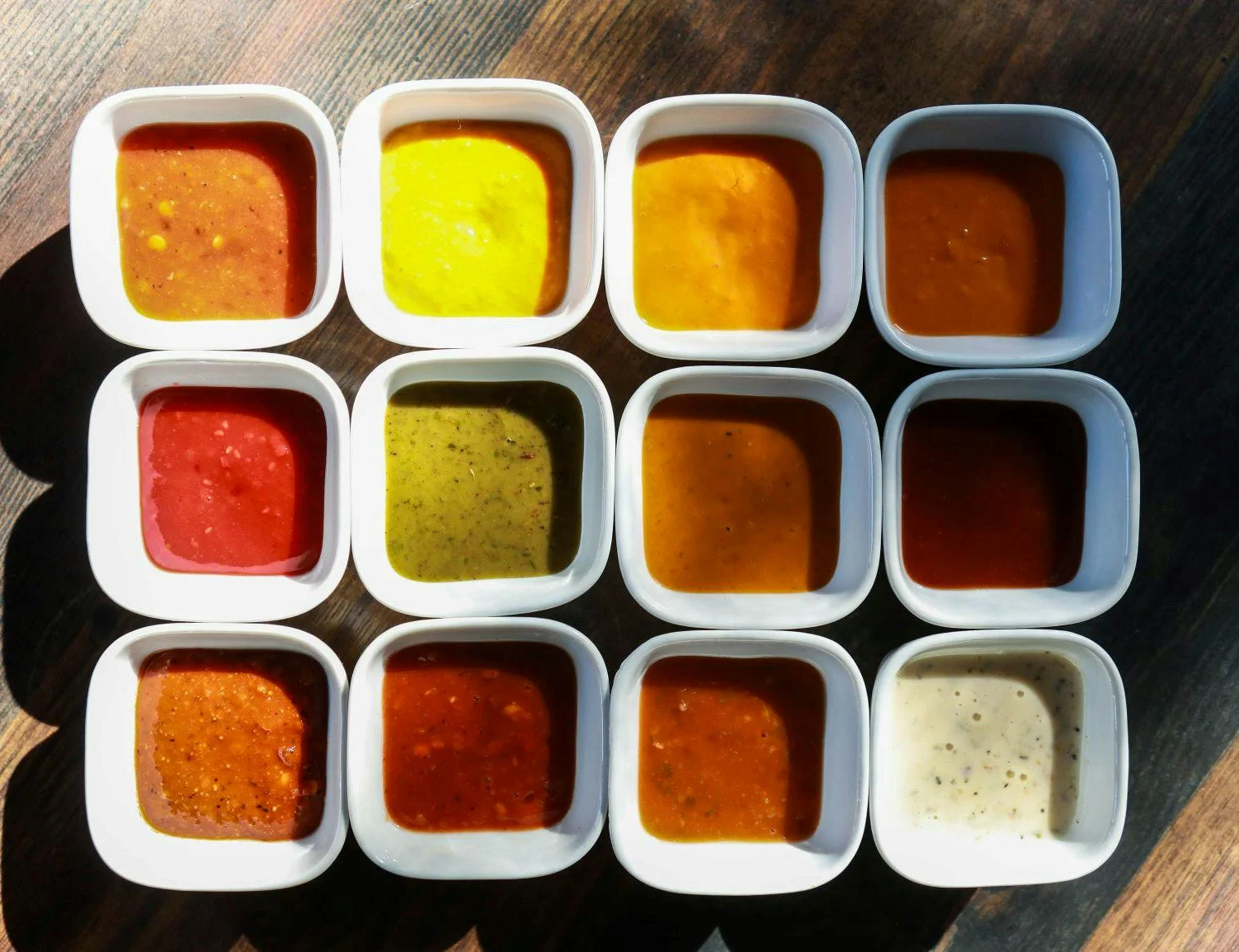 Variety of colorful dipping sauces in small bowls