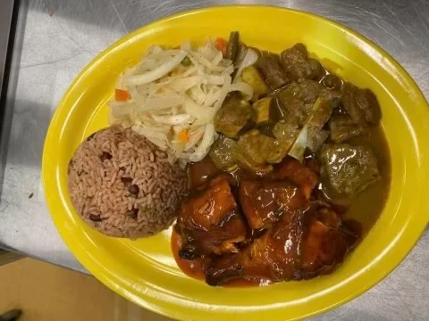 Jamaican jerk chicken with rice and peas, served with steamed vegetables