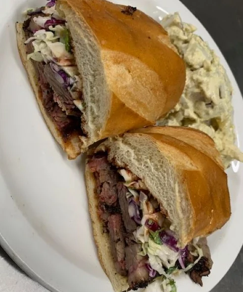 Smoked brisket sandwich with coleslaw on a toasted bun