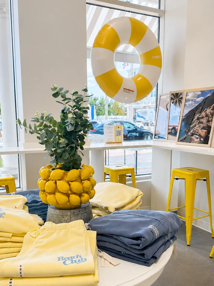 seating area with decorative table that holds merchandise