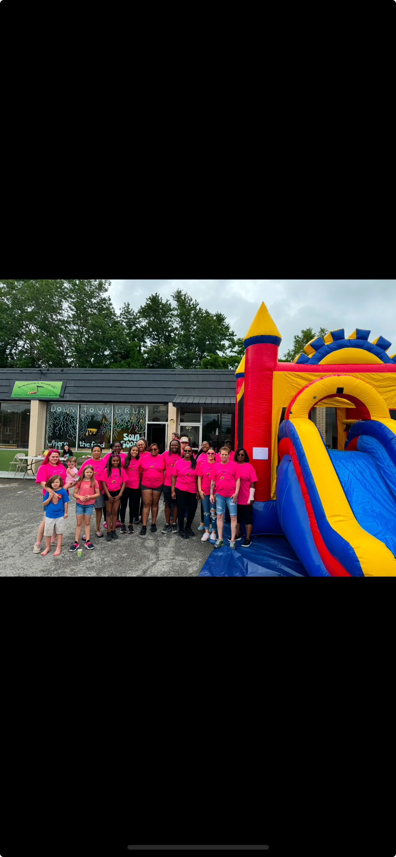 Group of staff in pink shirts at a family-friendly restaurant event