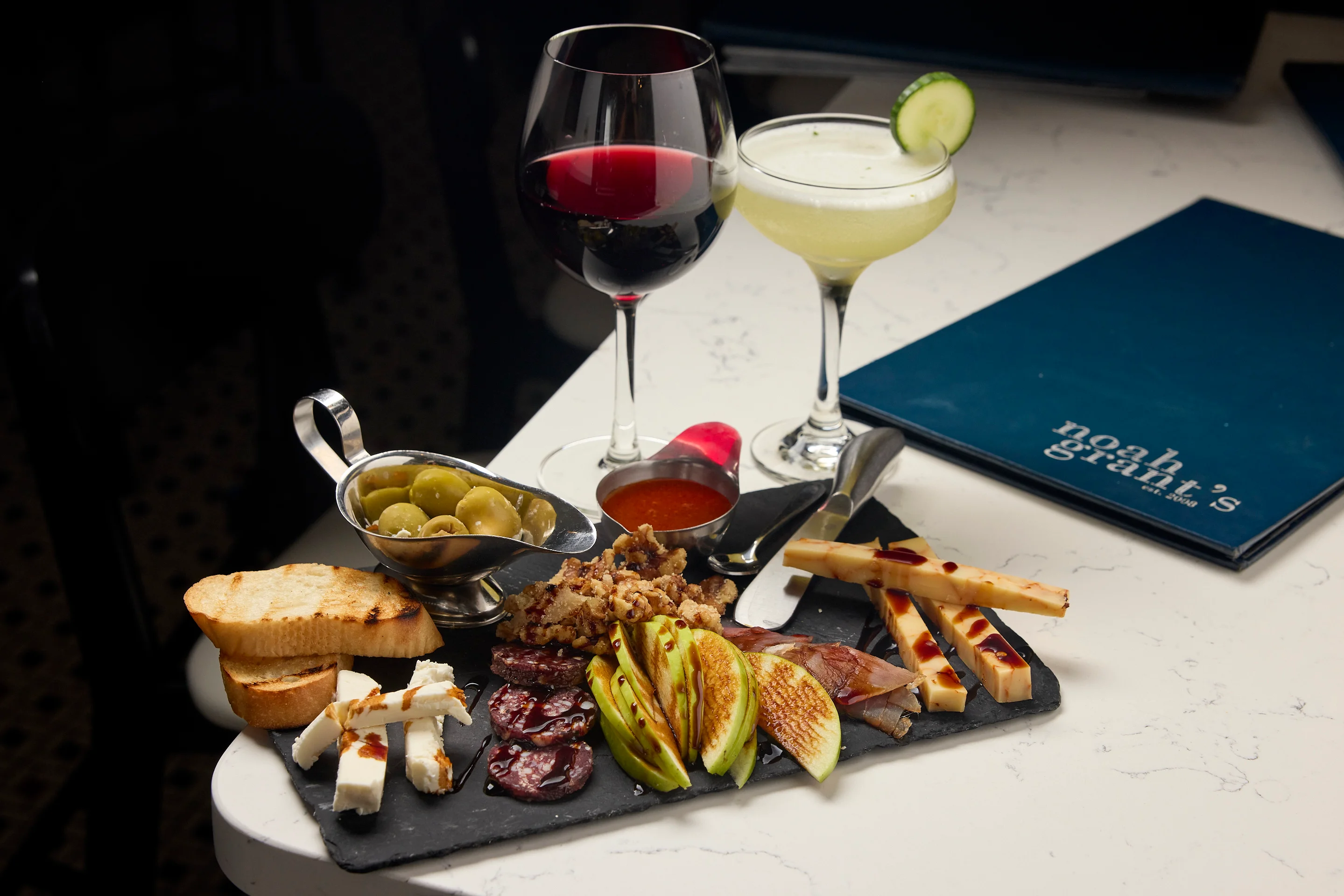 Charcuterie board with wine and cocktails in a modern restaurant
