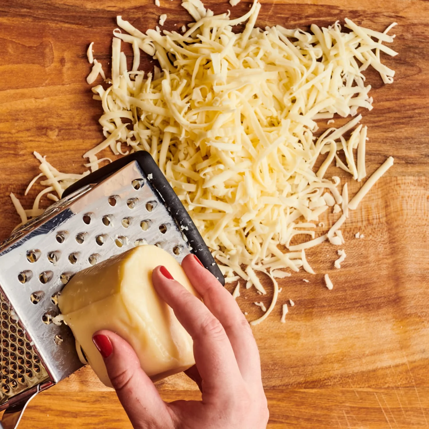 Grated cheese on a wooden cutting board