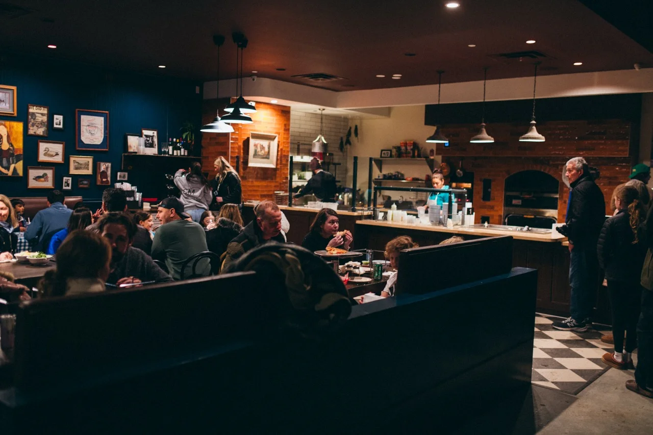 Cozy restaurant interior with warm lighting and lively atmosphere