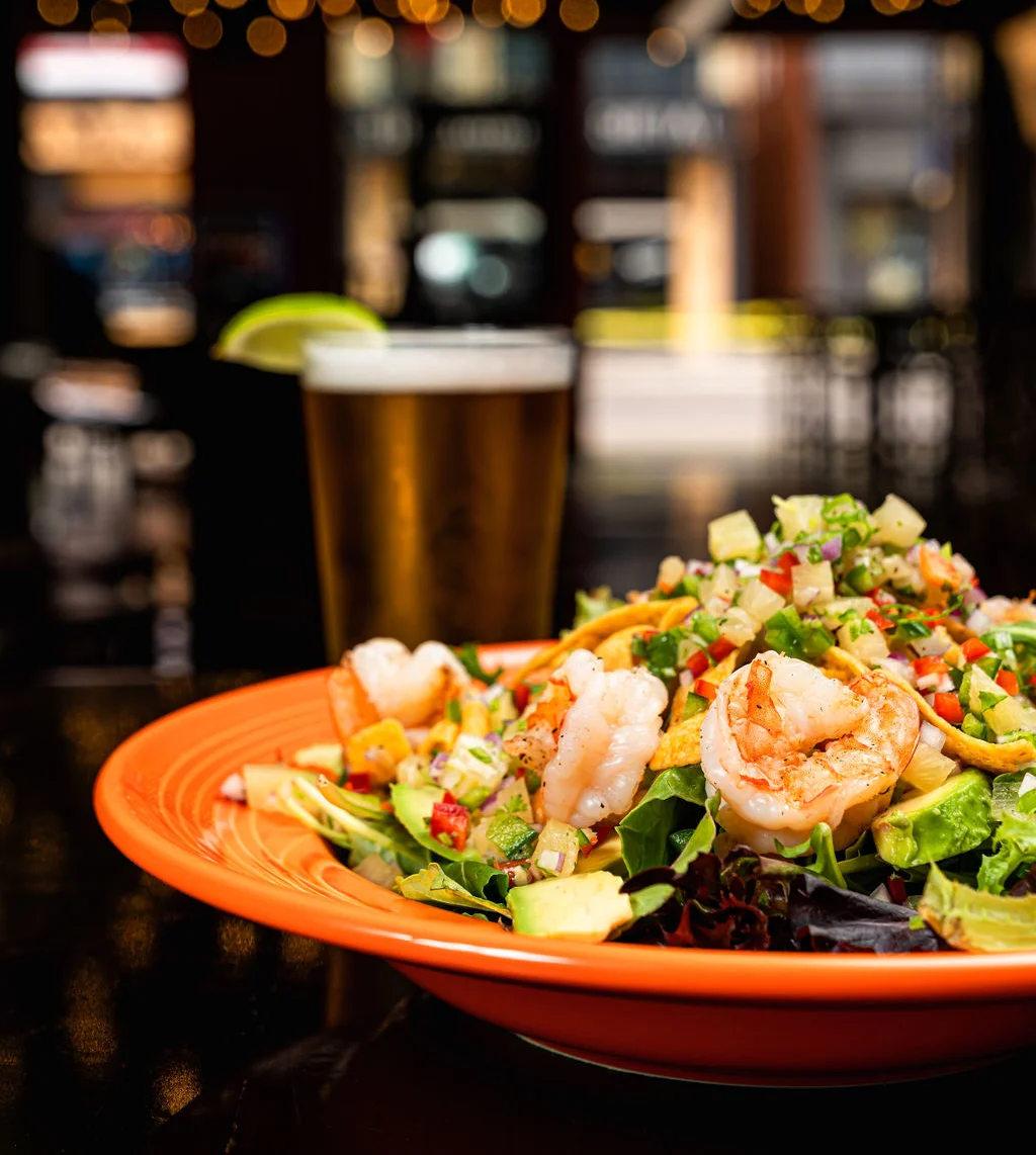 Shrimp salad with fresh vegetables in a vibrant restaurant setting