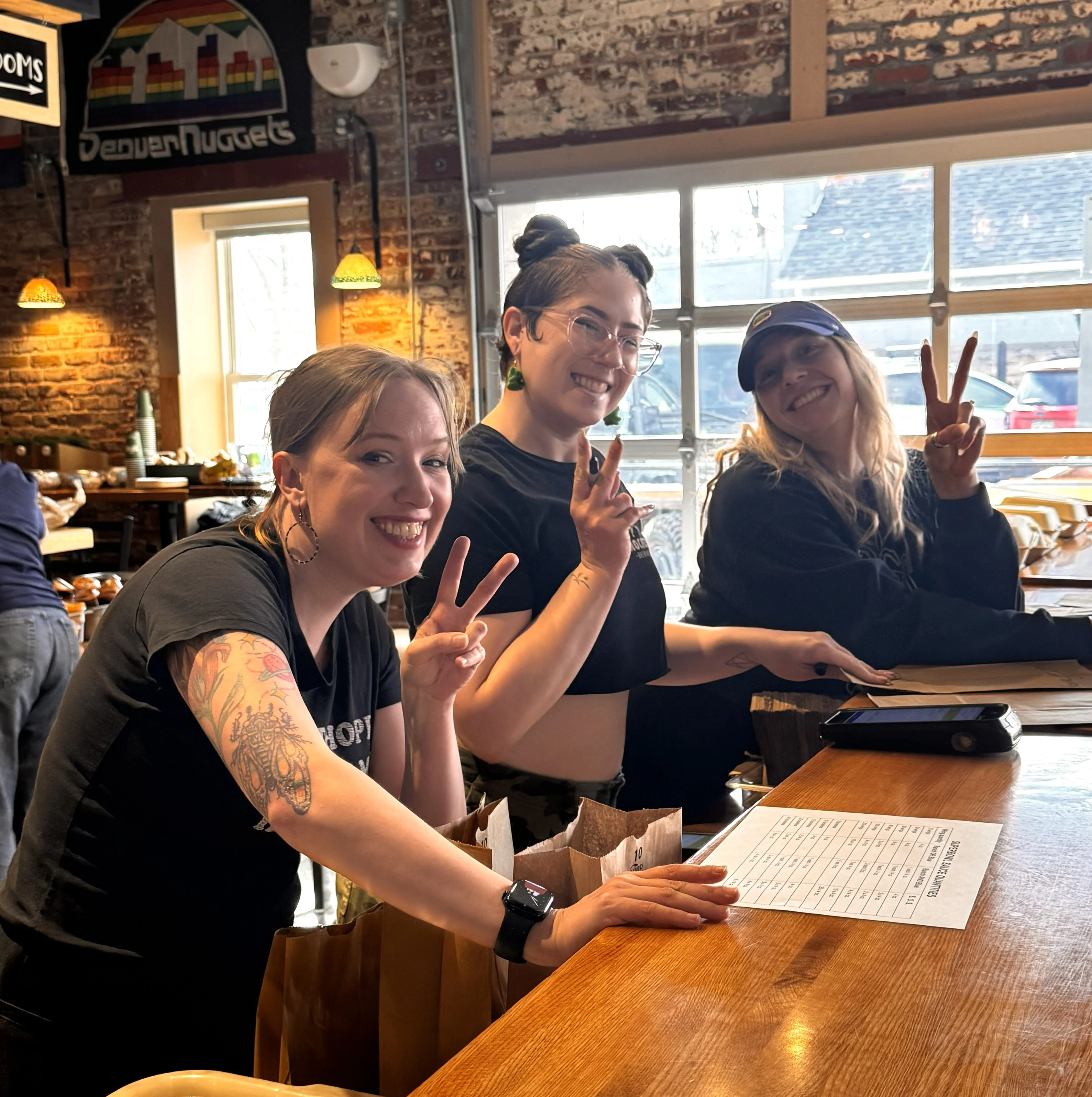 Friendly staff posing in a cozy restaurant interior