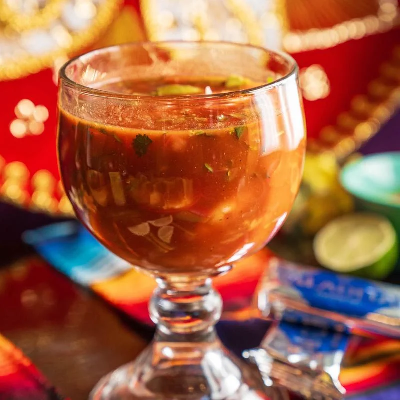 Refreshing Mexican michelada in a glass with garnishes