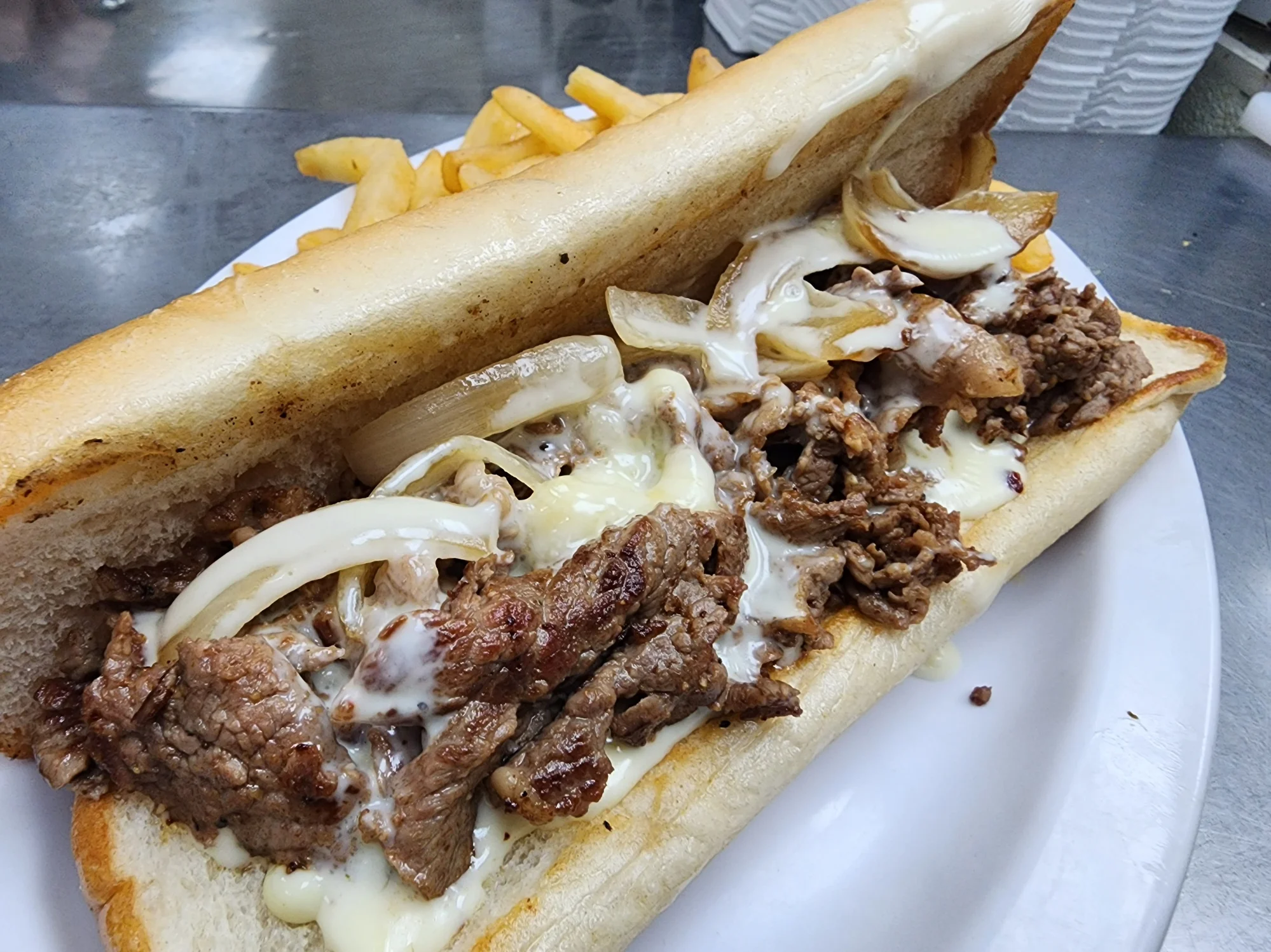 Philly cheesesteak sandwich with grilled onions and melted cheese