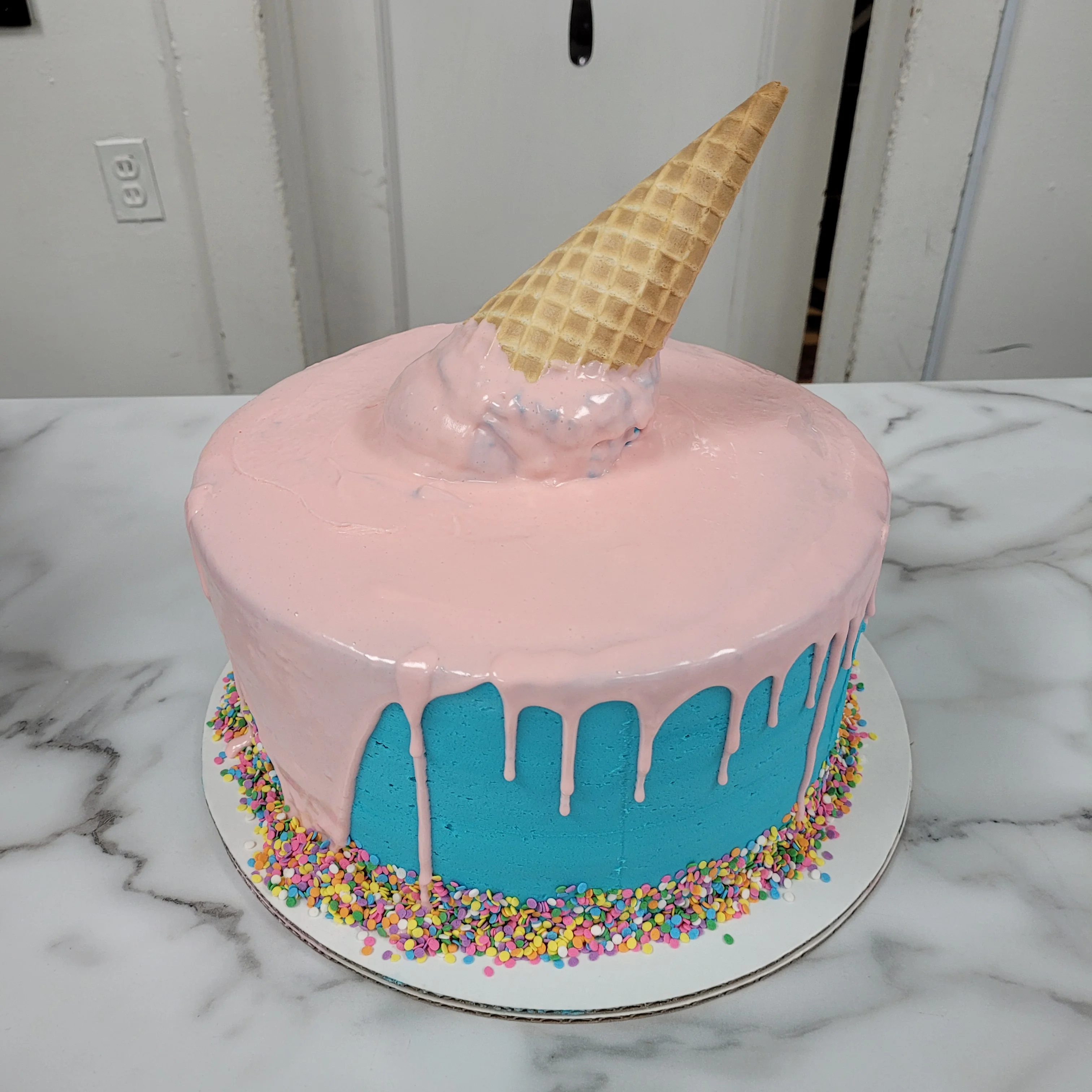 Colorful ice cream cake with cone and sprinkles