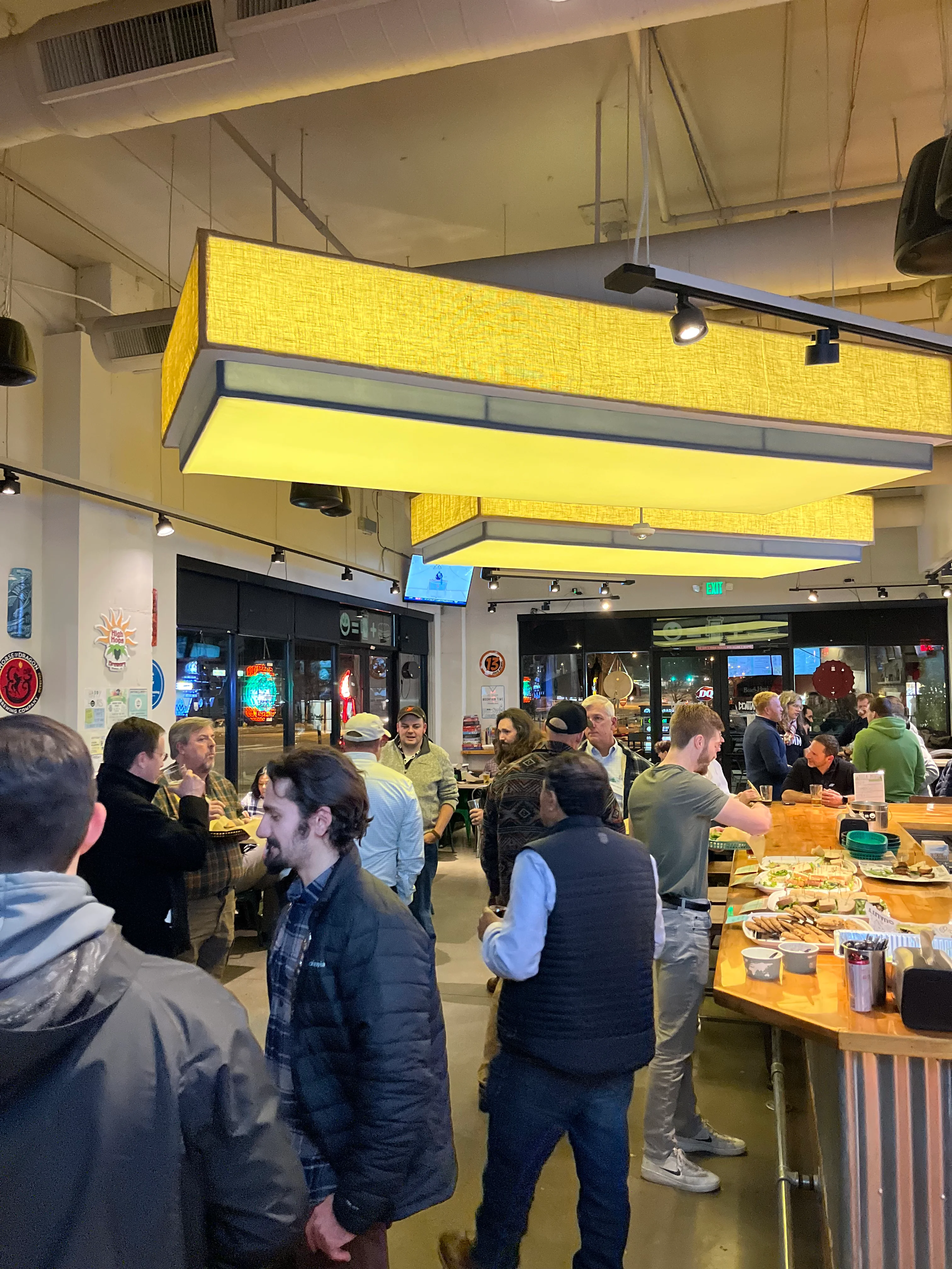 Lively restaurant interior with patrons enjoying food and drinks