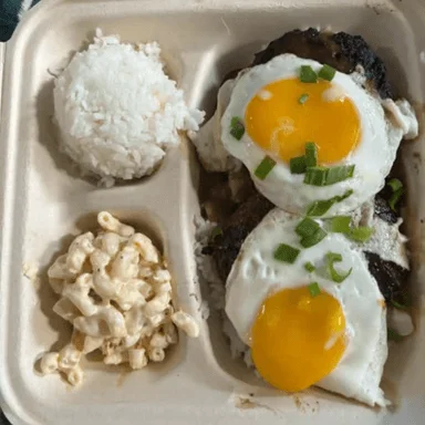 Eggs, sunny side up, paired with rice and macaroni