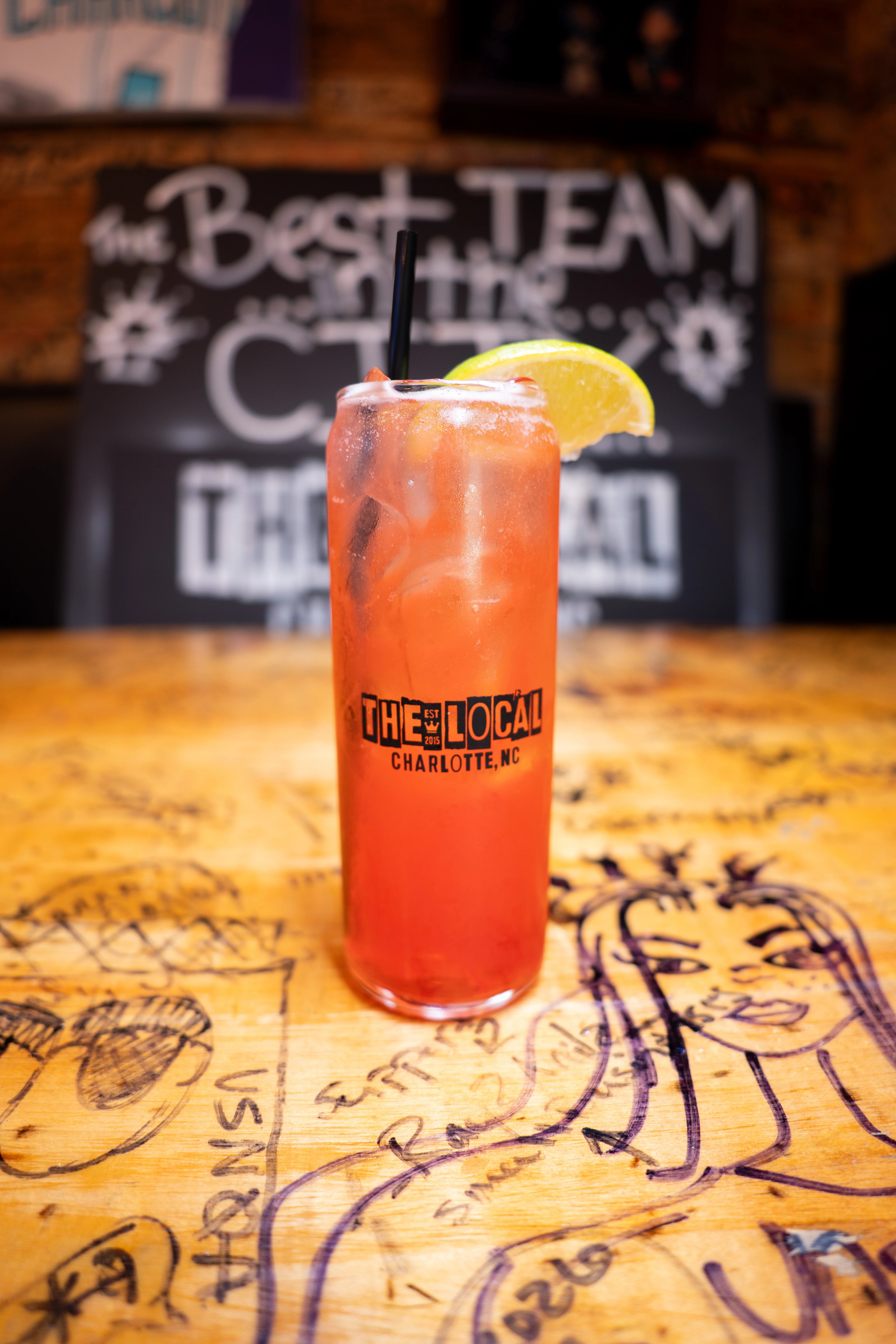 Refreshing cocktail with citrus garnish at a lively bar