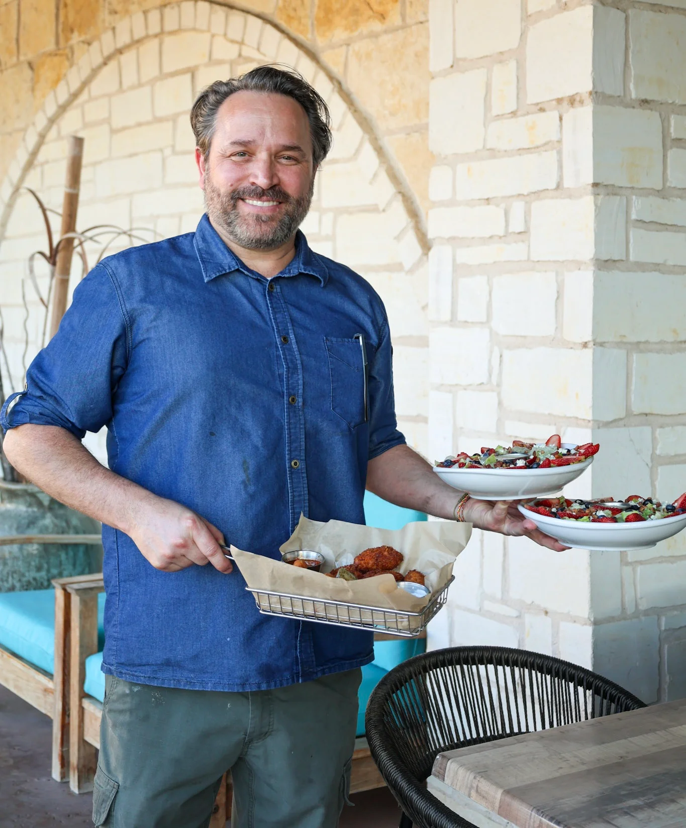 Chef serving Southern fried chicken and colorful salads