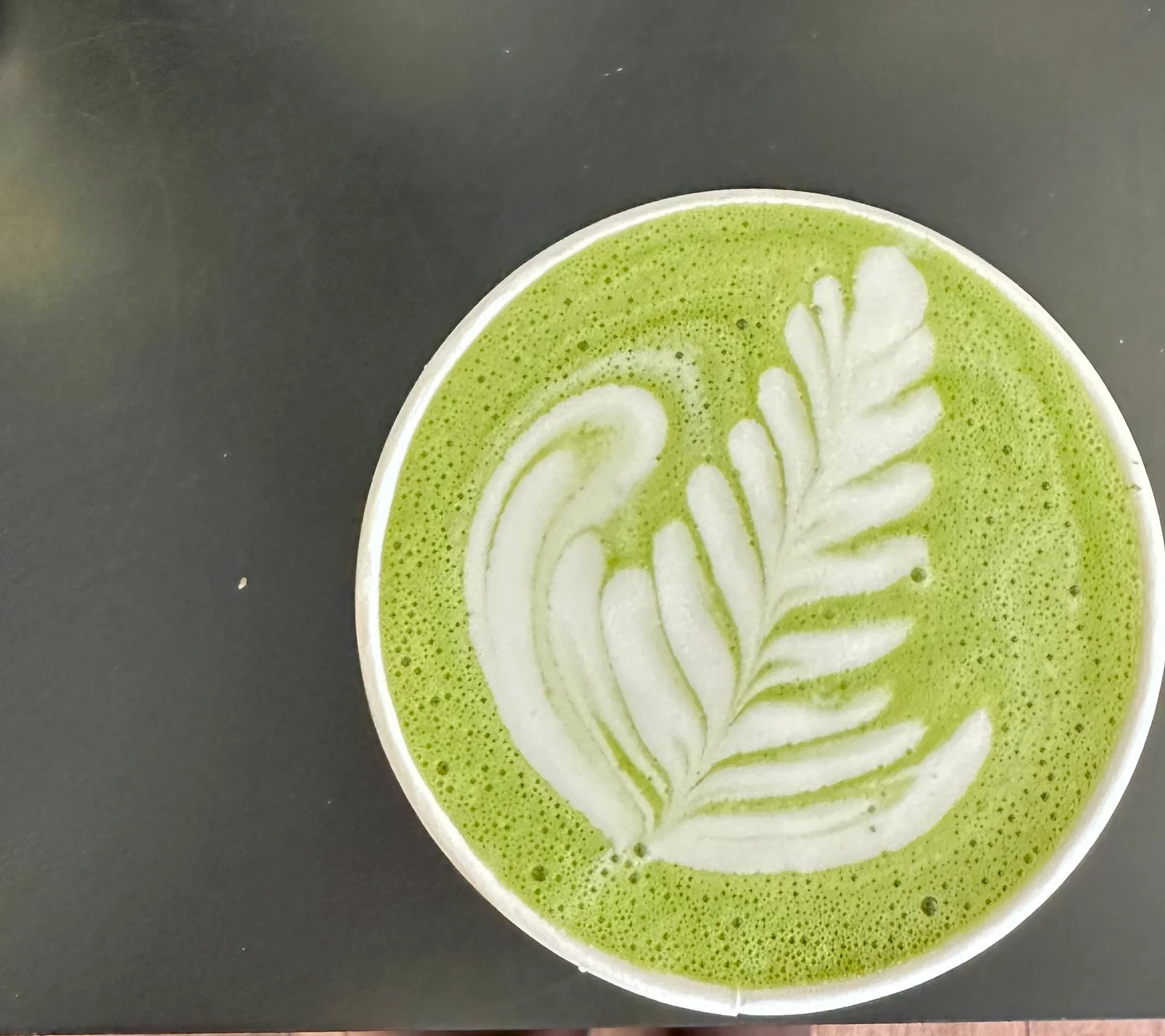 Matcha latte with intricate latte art design