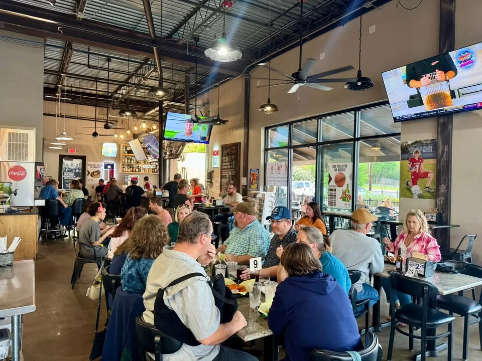 Lively restaurant interior with diners enjoying meals and drinks