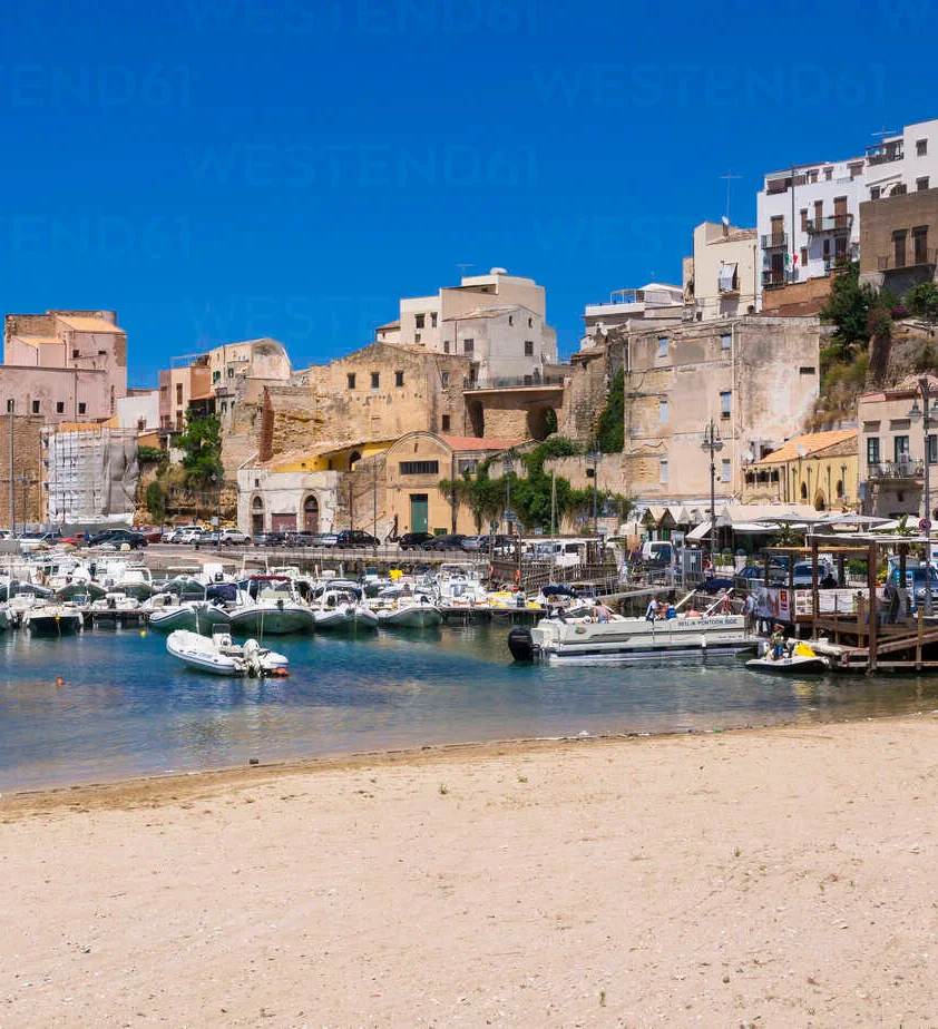 Scenic coastal view of a harbor with boats and historic buildings