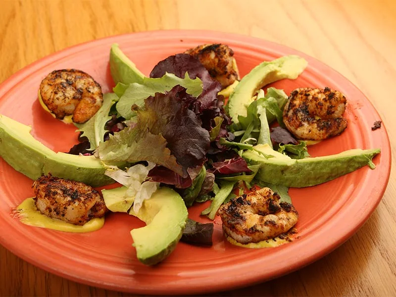 Grilled shrimp salad with avocado and mixed greens
