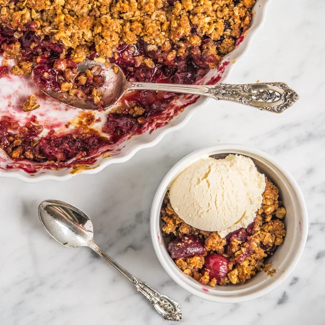 Warm cherry crisp topped with vanilla ice cream