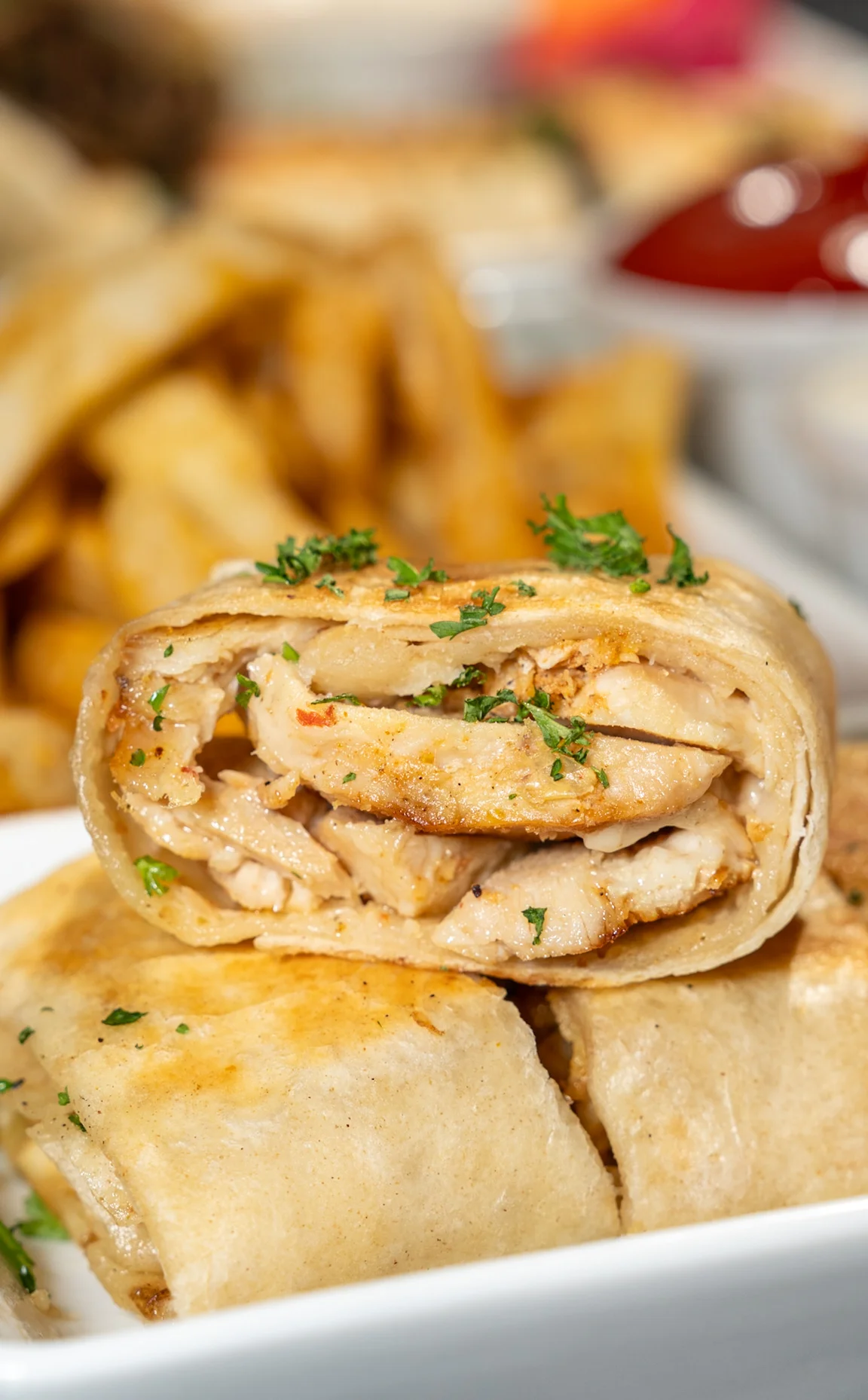 Close-up of a delicious chicken dish with vibrant spices and garnishes.