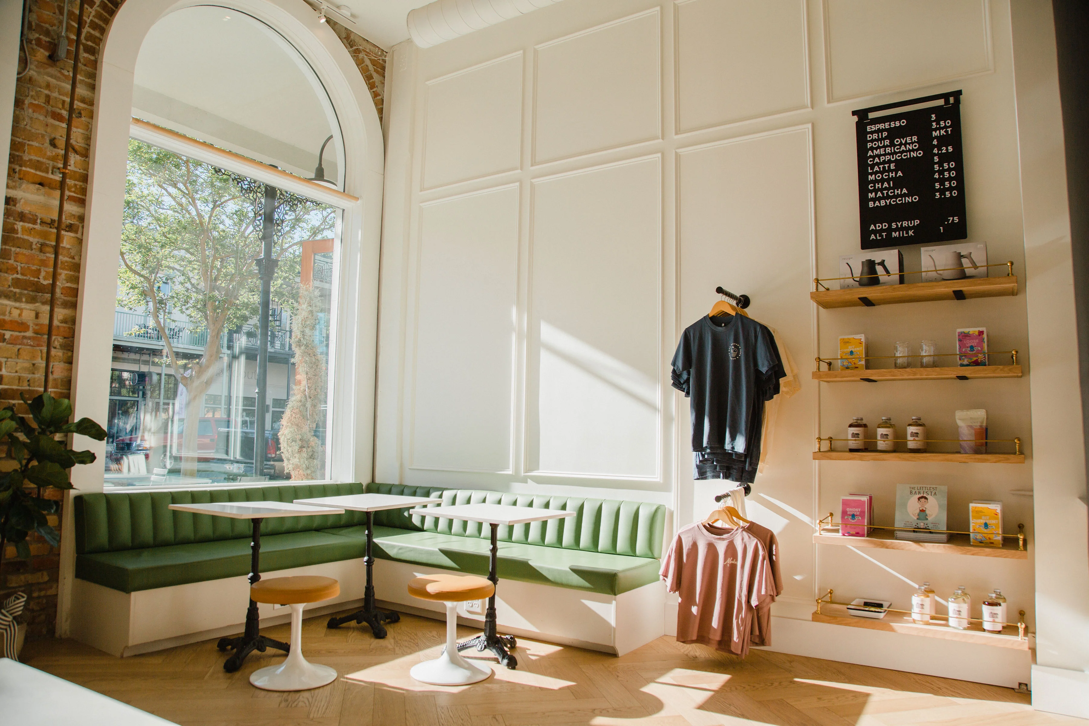 Cozy café interior with green seating and menu board