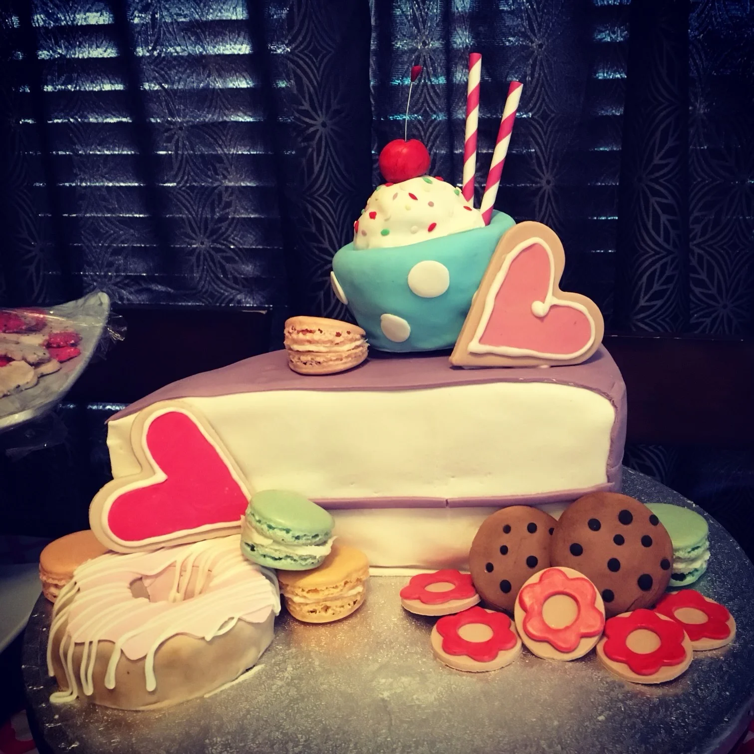 Colorful cake with ice cream, cookies, and macarons, perfect for celebrations