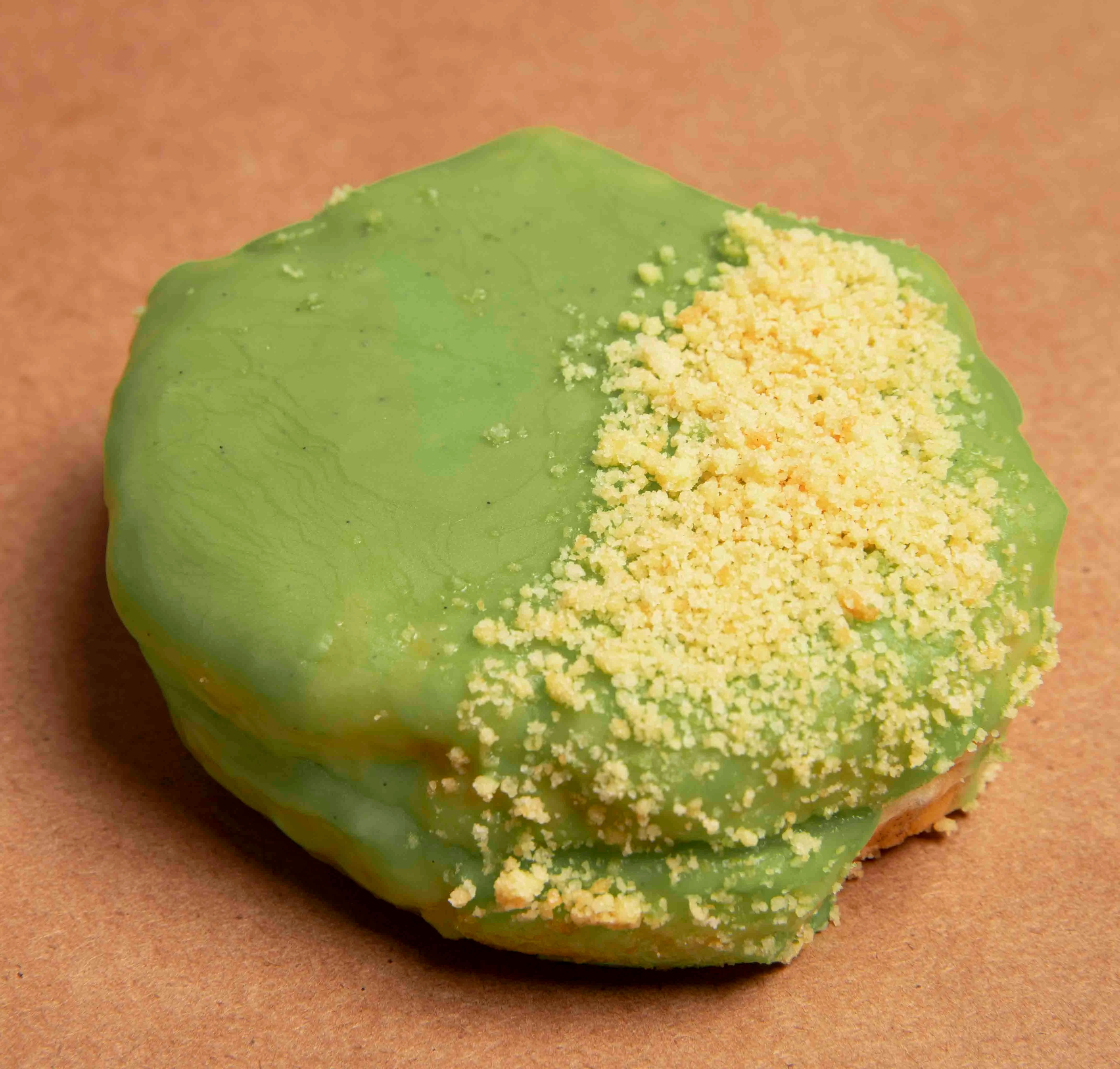 Matcha donut topped with yellow crumble