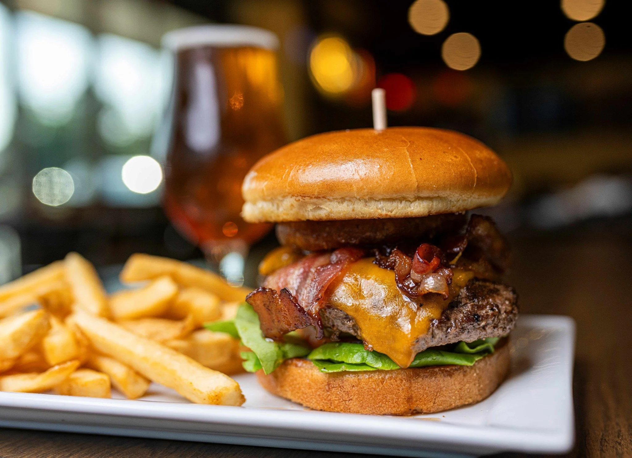 Juicy cheeseburger with bacon and fries