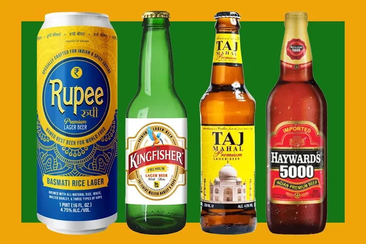 A selection of Indian beers displayed on a wooden table.