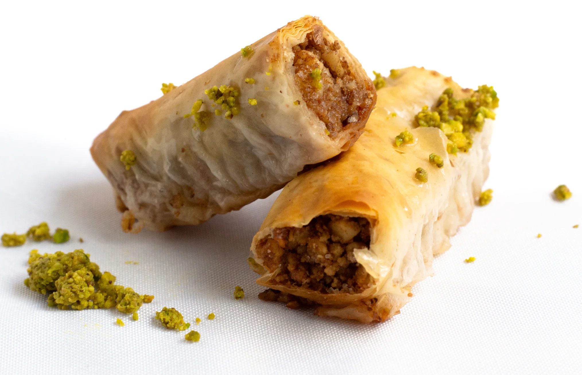 Delicious baklava with pistachios on a white background