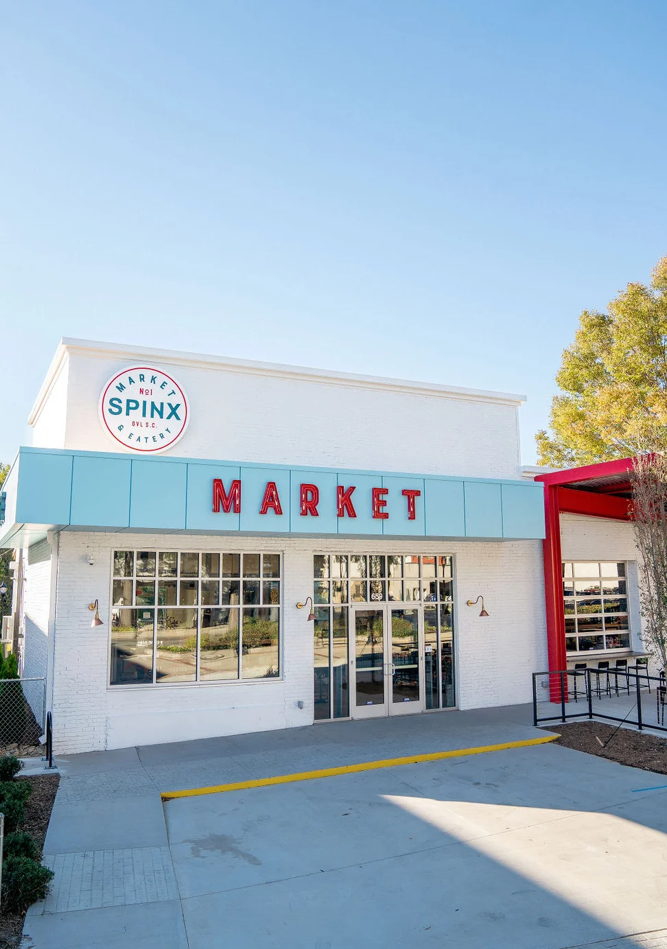 Exterior view of Spinx Market eatery with bright signage