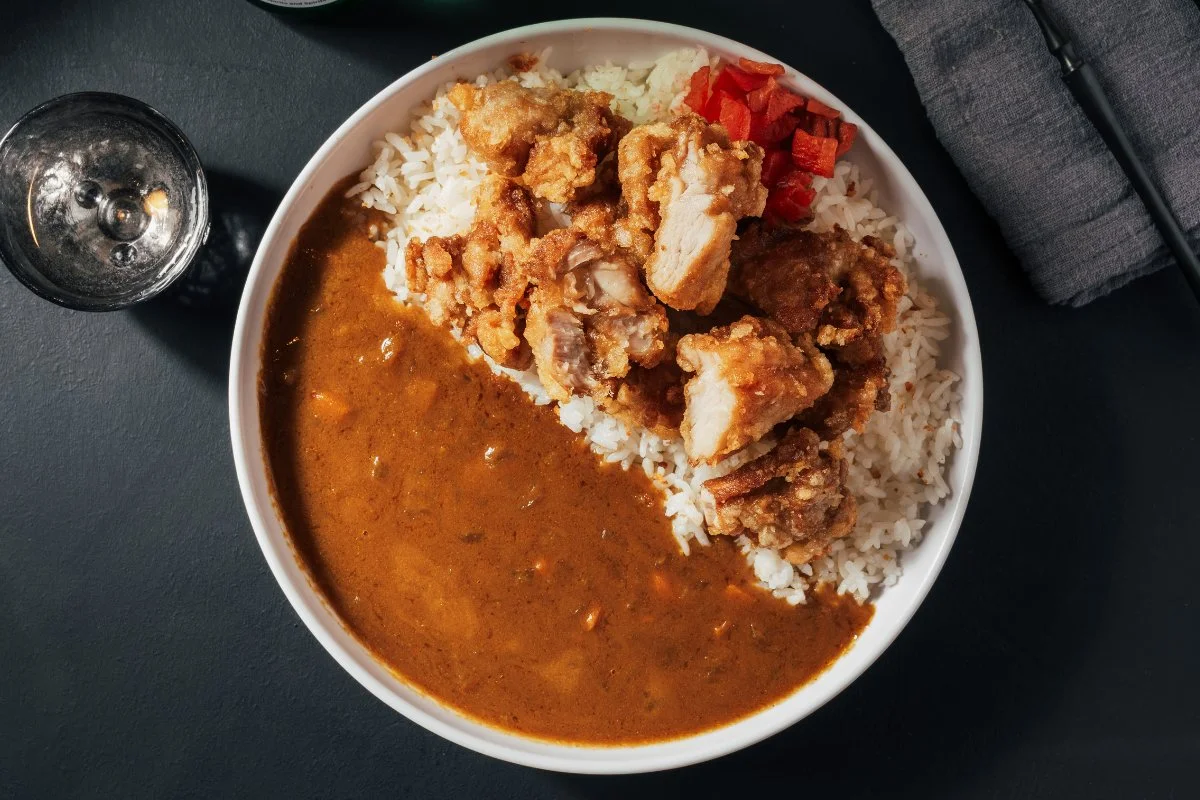 Delicious Curry Katsu Donburi served in a bowl with rice and toppings.