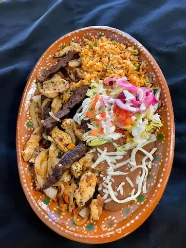 Sizzling Mexican fajitas platter with rice and salad