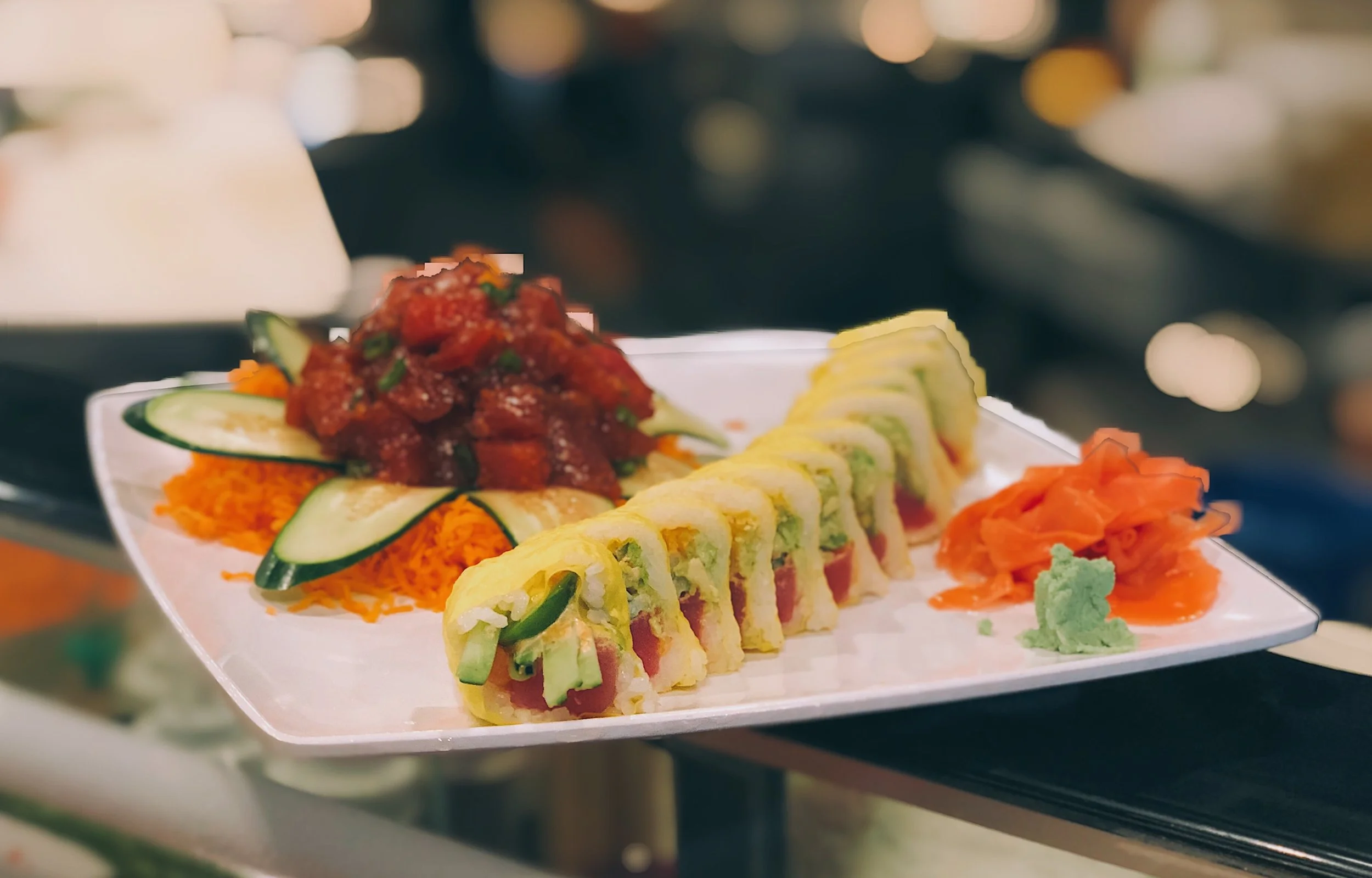 Colorful sushi platter with rolls and spicy tuna tartare