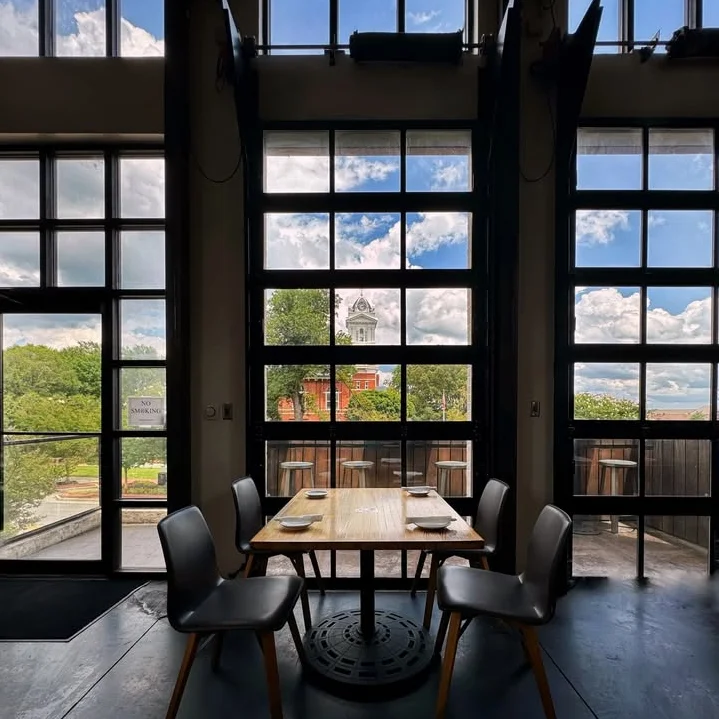 Modern restaurant interior with large windows and scenic view